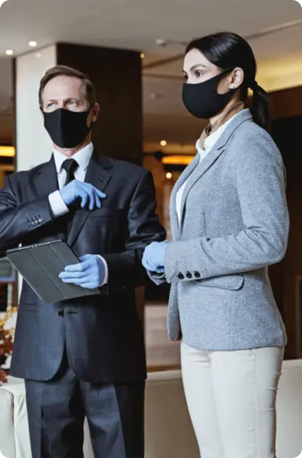 A man and a woman wearing face masks.