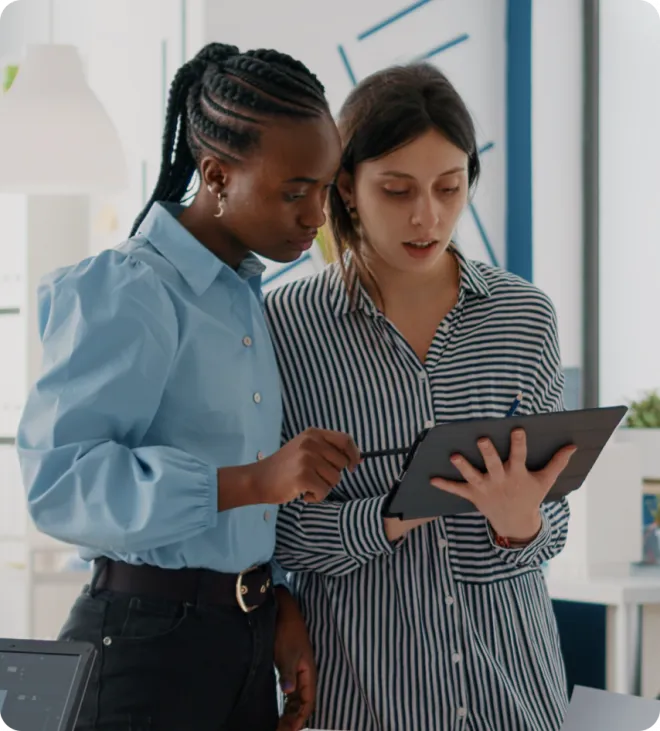 Two women using a tablet.