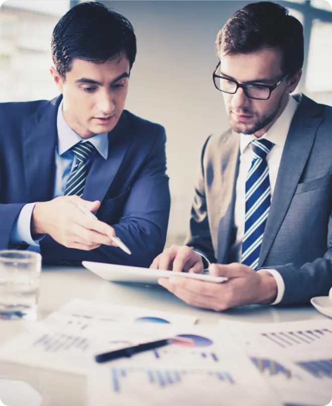 Two men working at a desk.