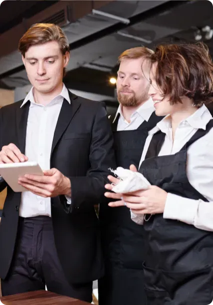 Restaurant employees using a tablet.
