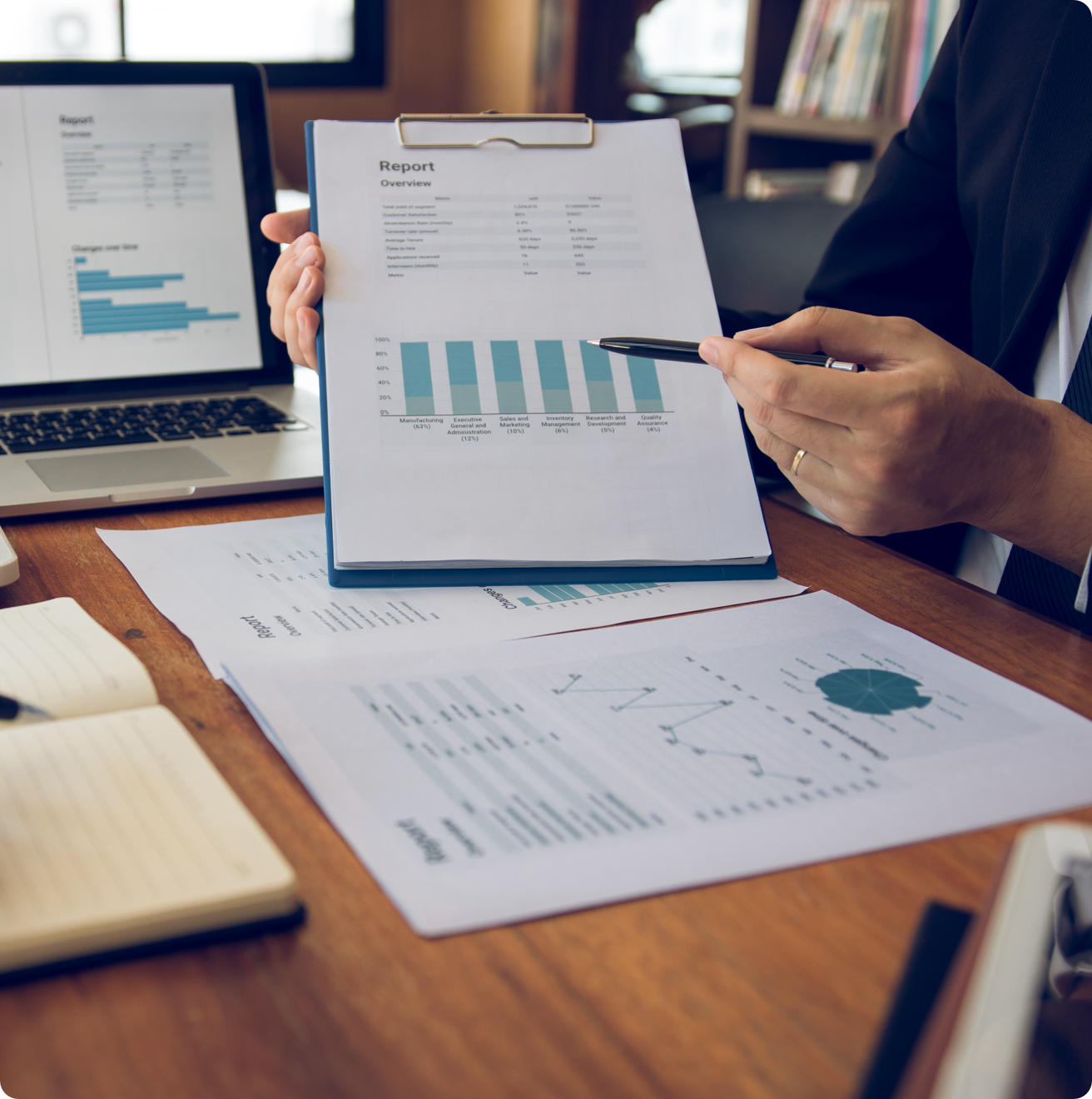 A person wearing a gold wedding band, pointing to a computer tablet with a pen.