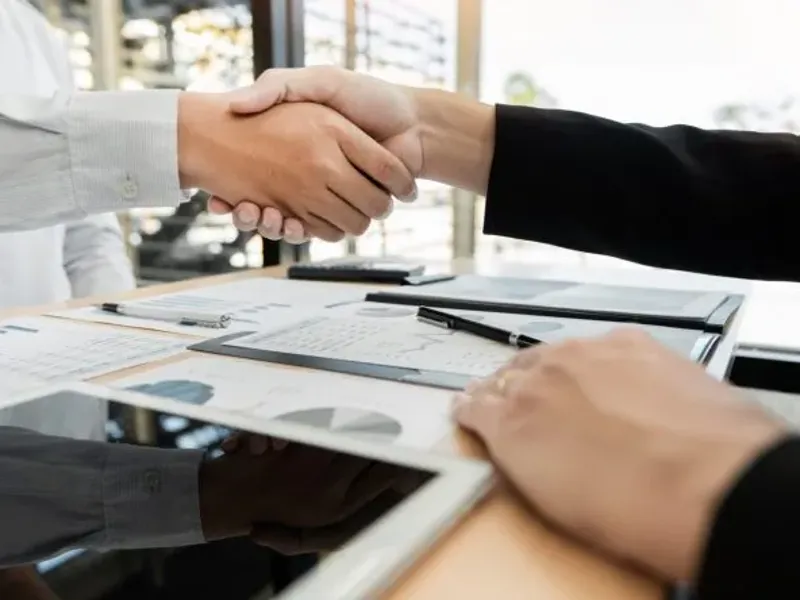 Two business people shaking hands.