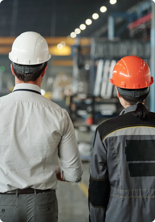 Man and woman in a warehouse.