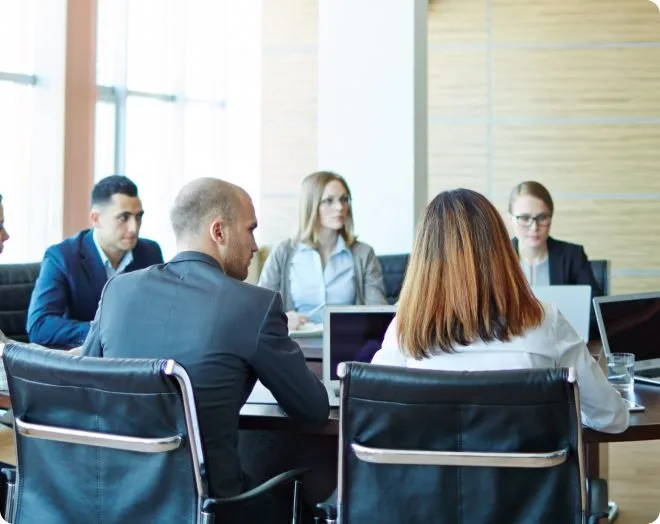 Large group meeting in a board room.