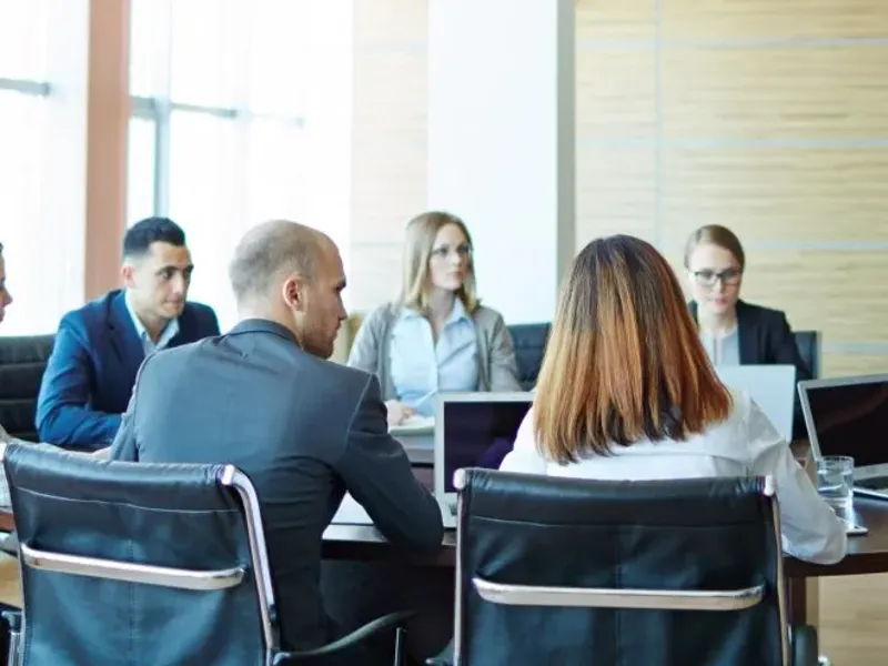 Large group meeting in a board room.