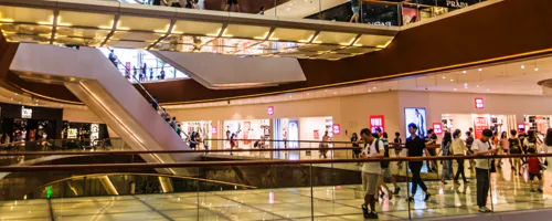 Landscape view of a shopping center filled with shoppers.