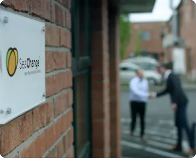SeaChange logo on a brick wall.