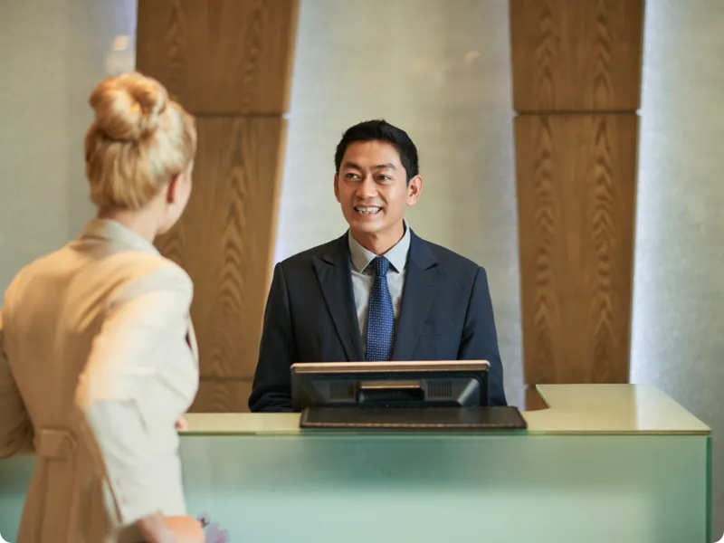 Business women checking in at the front desk.
